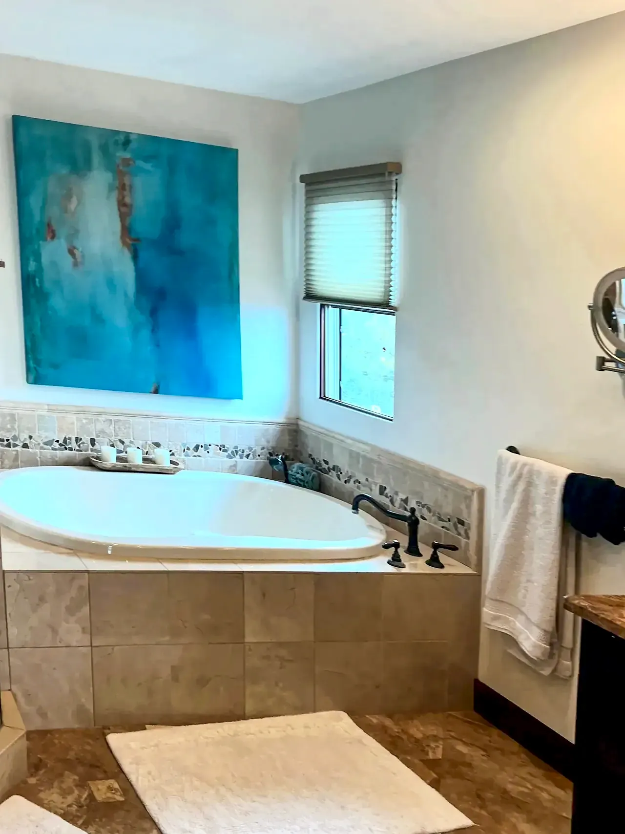 Del Mar primary bathroom before the remodel, with a drop-in tub set in a beige tile deck below a corner window